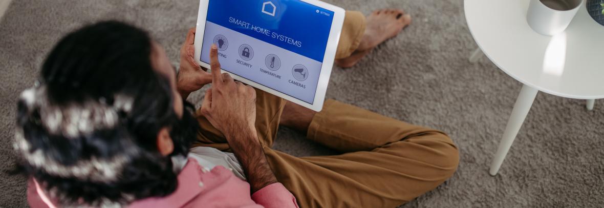 Man adjusting household functions, lighting, security cameras, door locks and thermostat or heating settings in the smart home system. - stock photo